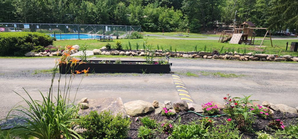 view of campground landscaping, pool, and playset