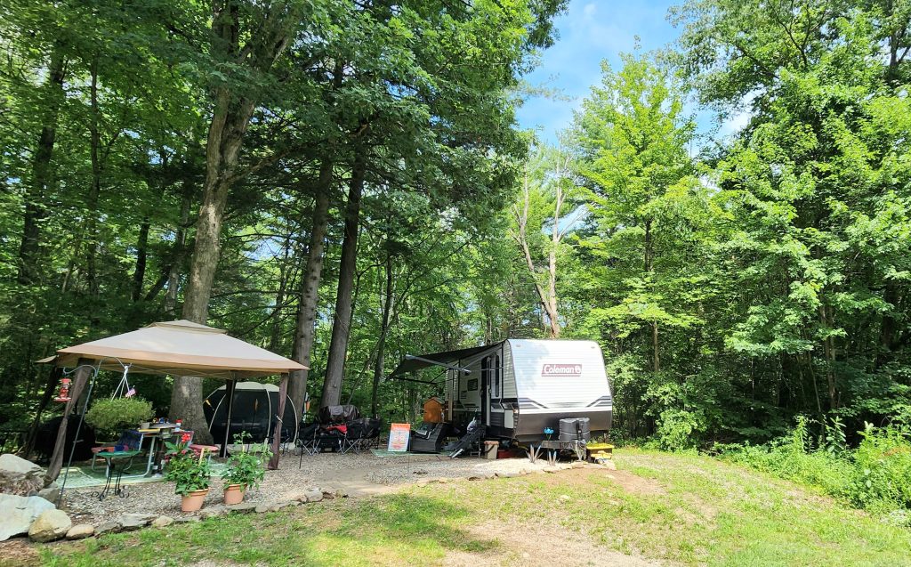 RV set up in woodsy campsite